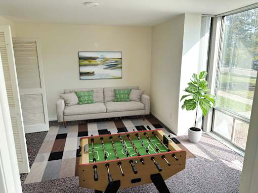 a living room with a pool table and a couch