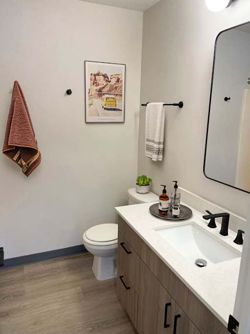 a small bathroom with a toilet sink and mirror