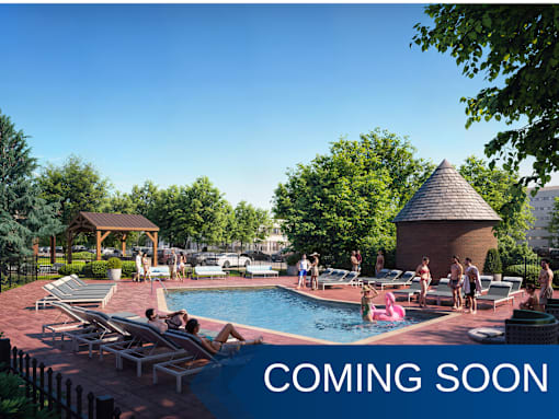 A pool area with people relaxing and a gazebo in the background.