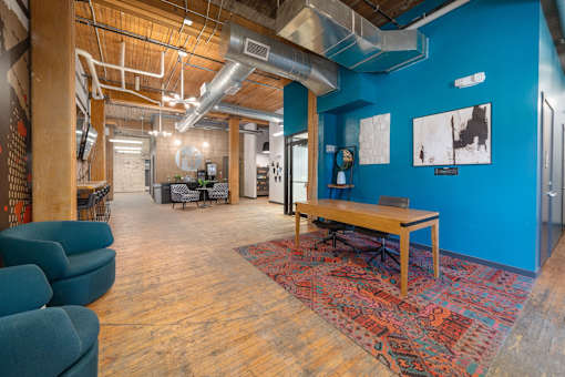 a large room with blue walls and a wooden table in the middle of the room