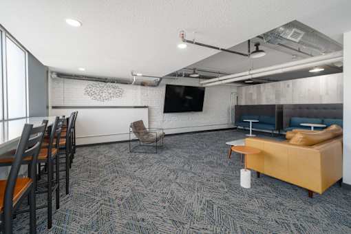 a room with a couch chairs and a table