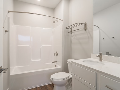 Bathroom with tub and shower at apartments in Haslett, Michigan | Newton Place Apartments in Haslett MI