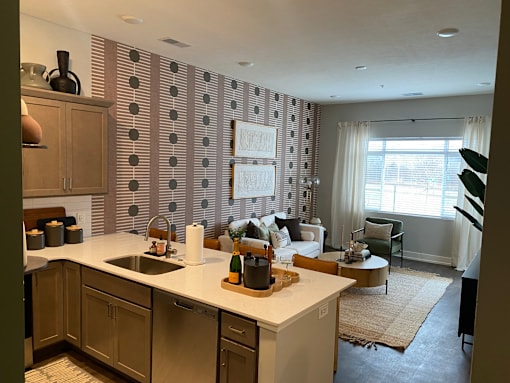 Spacious living room and kitchen at Newton Place Apartments in Haslett, Michigan