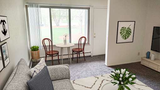 Living room and dining in Okemos Village Apartments in Okemos, MI