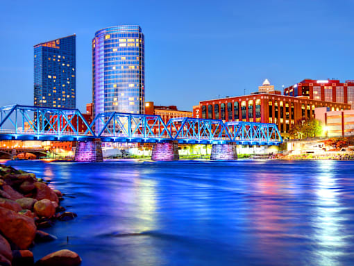 A bridge over a body of water with buildings in the background.