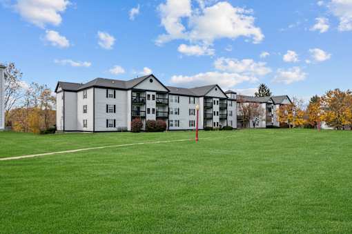 Apartment complex with a green lawn in front.