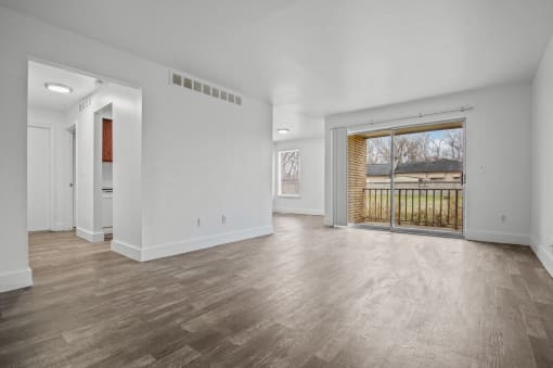 the living room of a new home with a large door to the backyard