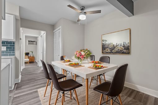 A dining room with a table set for four.