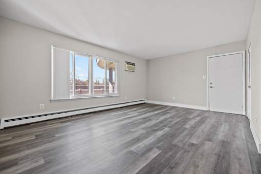 A room with a grey floor and a white door.