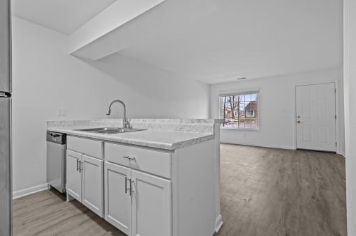 a kitchen with white cabinets and a large counter top