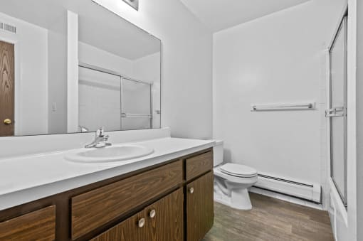a bathroom with a toilet sink and shower