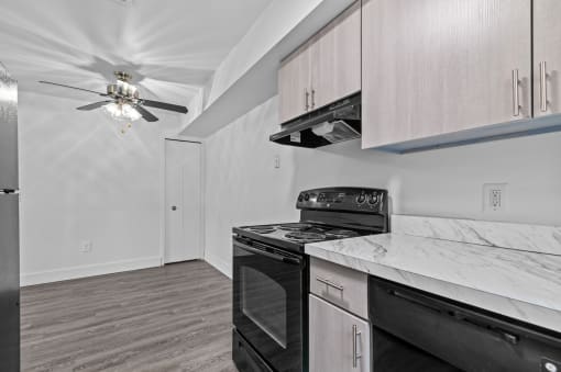 a kitchen with white cabinets and a black stove top oven