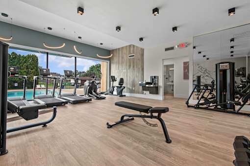 A gym with treadmills, weights, and exercise equipment at Park On Canal Apartments - Clinton Twp, MI Apartments, Clinton Twp, MI, 48038
