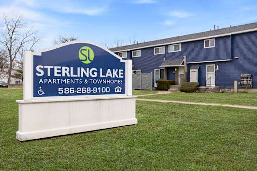Sterling Lake Apartments & Townhomes sign in front of a building.