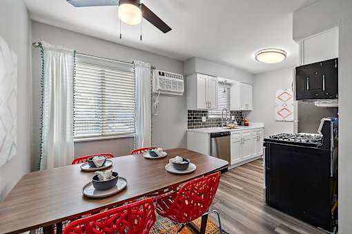 a kitchen and dining room with a wooden table and chairs