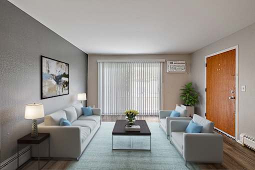 A living room with a grey couch, a coffee table, and a painting on the wall.