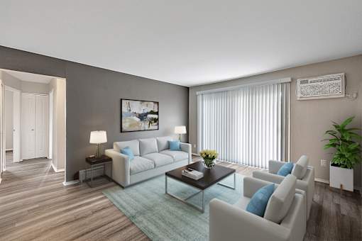 A living room with a grey couch, a coffee table, and a painting on the wall.