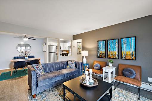 A living room with a blue couch and a black coffee table.