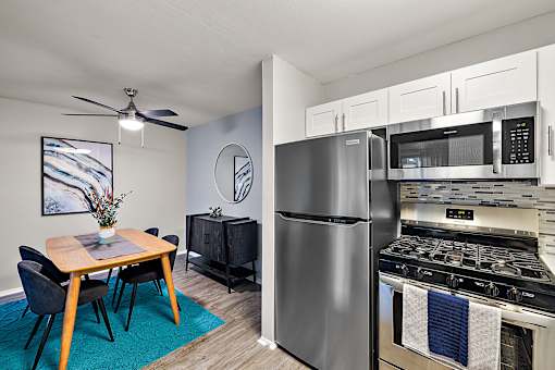 A modern kitchen with a dining table and chairs.