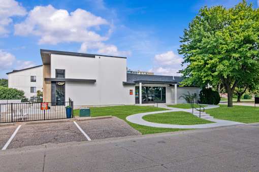 A white building with a black gate in front at Park On Canal Apartments - Clinton Twp, MI Apartments, Clinton Twp