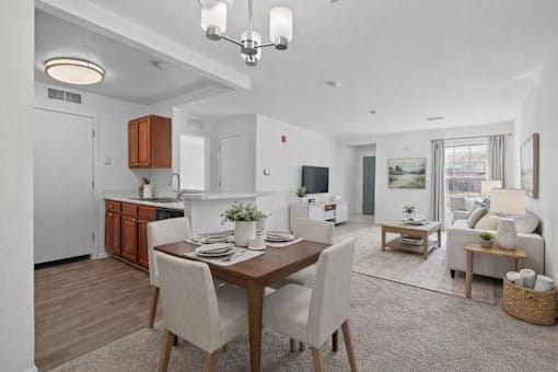 A modern kitchen with a dining table set for two.