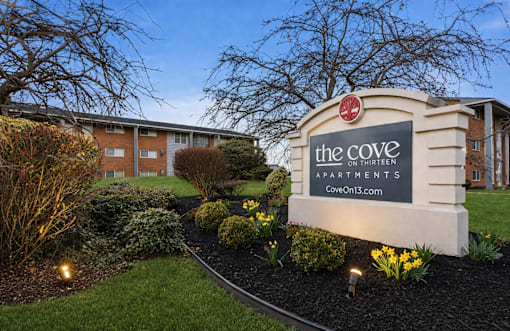 The Cove Apartments is a residential complex with a well-maintained garden in front.