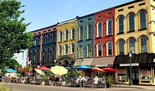 A row of colorful buildings with a street in front.