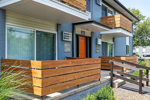 A blue house with a wooden fence in front.