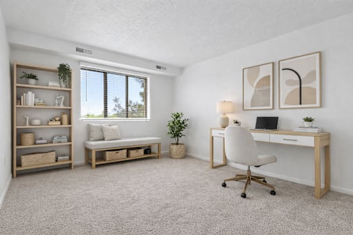 A room with a desk, chair, and shelves with plants and decorative items.