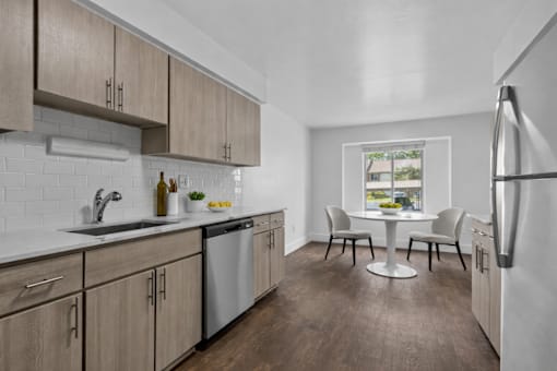 A kitchen with wooden cabinets and a white fridge.