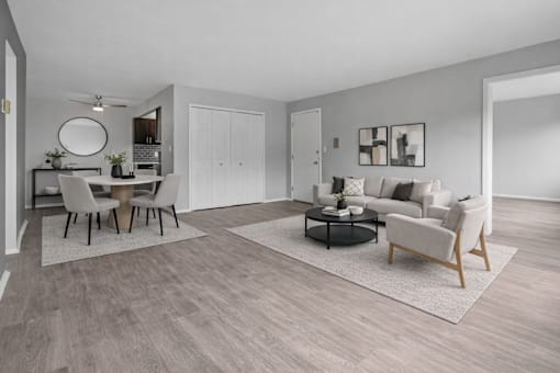 A modern living room with a dining table and chairs.