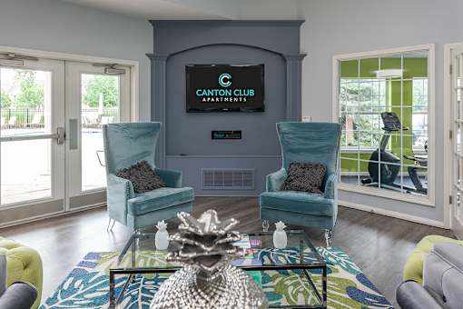 A living room with a sofa, armchair, and coffee table.