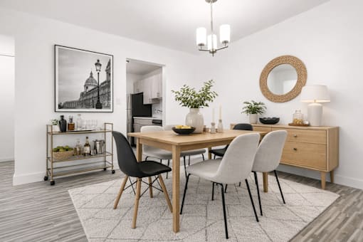 A dining room with a wooden table and chairs.