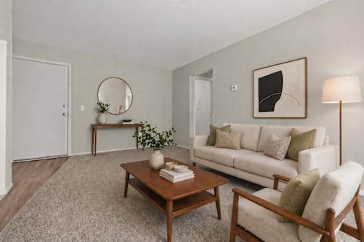 A living room with a couch, chair, and coffee table.