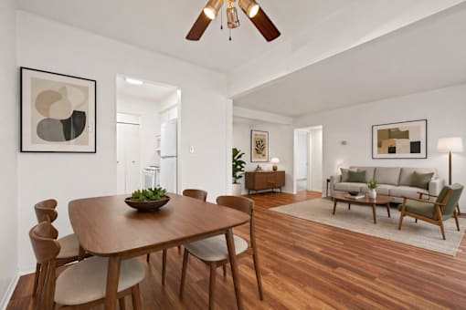 A modern dining room with a wooden table and chairs.