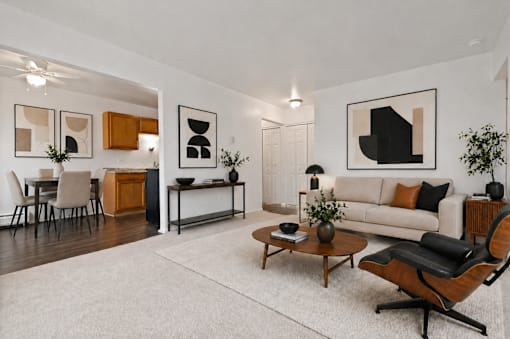 A modern living room with a white couch, a coffee table, and a chair.