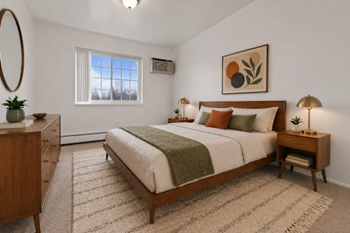A bedroom with a large bed, a nightstand, and a dresser.