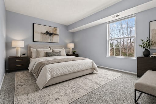 A bedroom with a large bed and a window.