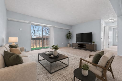 A living room with a couch, chair, and television.