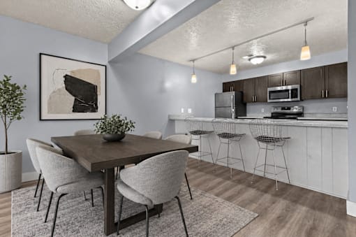 A dining area with a table and chairs.