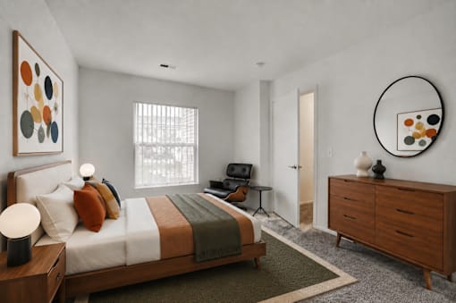 A bedroom with a bed, a chair, a dresser, and a painting on the wall.