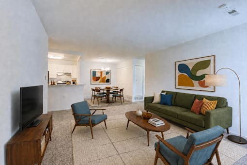 A living room with a green couch and a wooden coffee table.