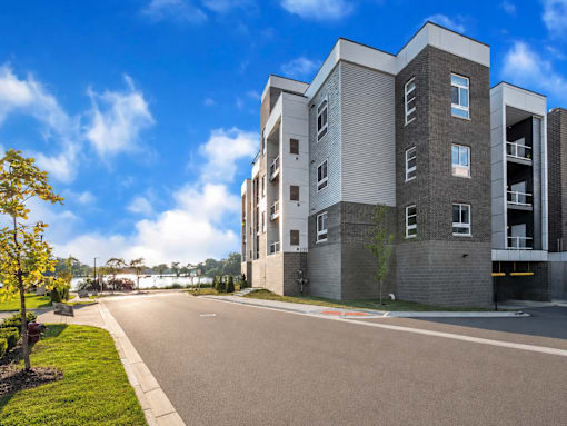 A modern apartment building with a clear blue sky above.