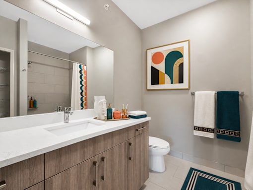 A bathroom with a white sink and a toilet.