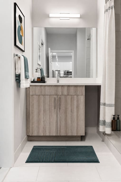 A bathroom with a sink and a mirror.