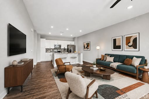 A modern living room with a green sofa and wooden furniture.