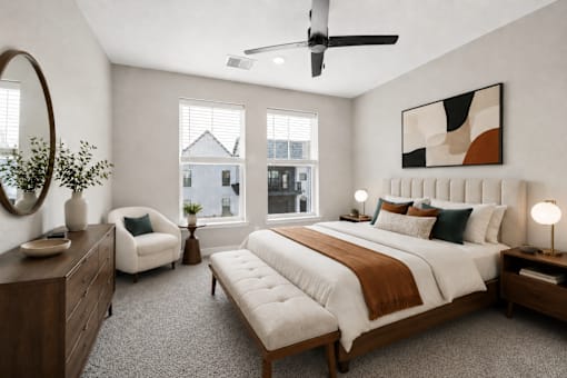 A bedroom with a large bed, a chair, and a mirror.