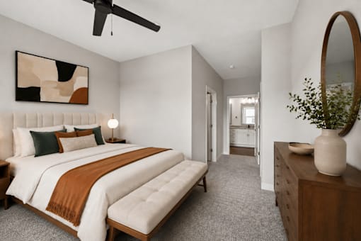 A bedroom with a large bed and a painting on the wall.