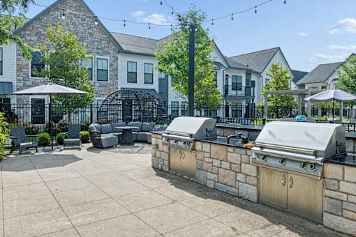 A patio area with a grill and seating area.