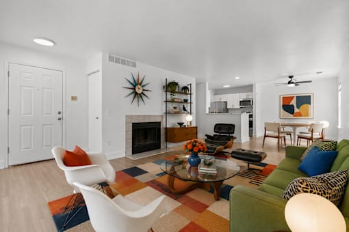 A living room with a leopard print couch and a white chair.